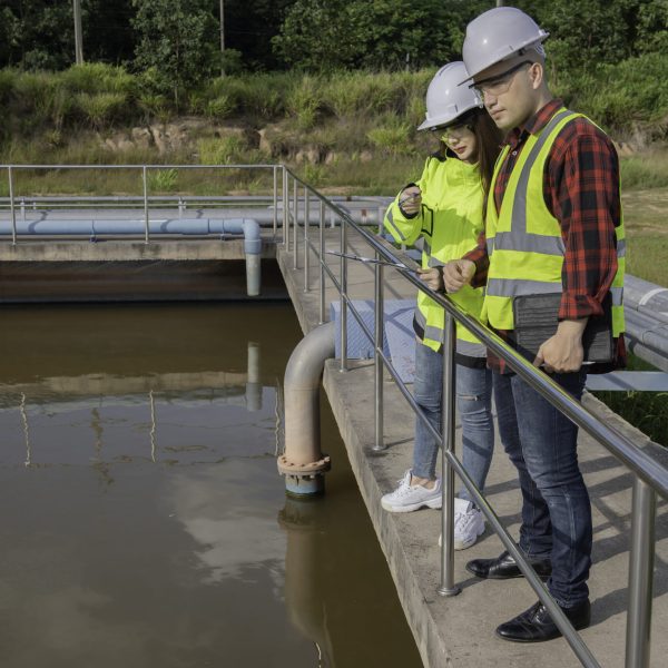 Environmental engineers work at wastewater treatment plants,Water supply engineering working at Water recycling plant for reuse,Technicians and engineers discuss work together.